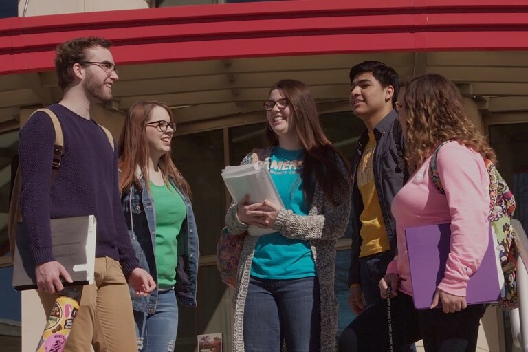 students outside building laughing
