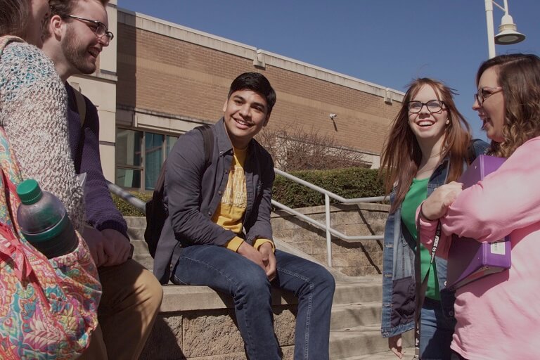 students talking by a set of steps